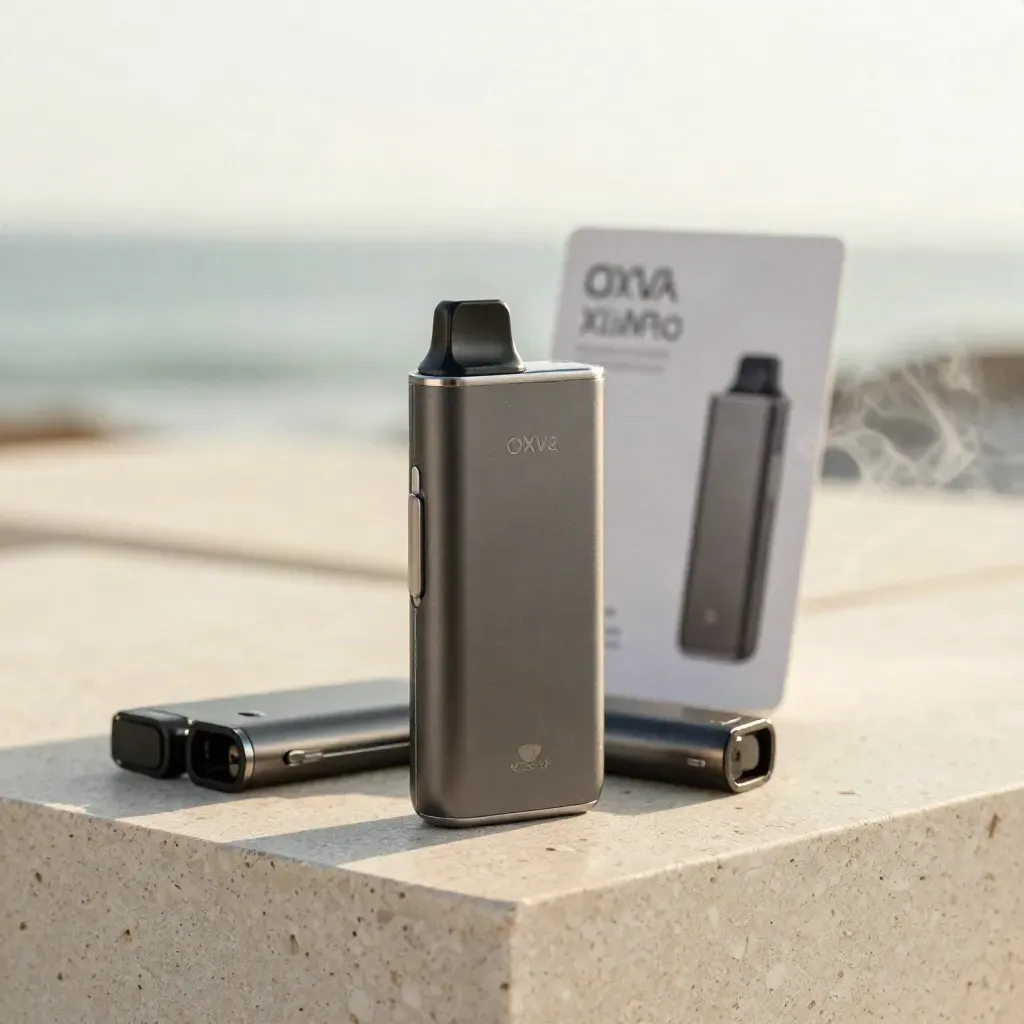 Pod vape kit with two spare pods on pale stone, softly lit with faint vapor haze.